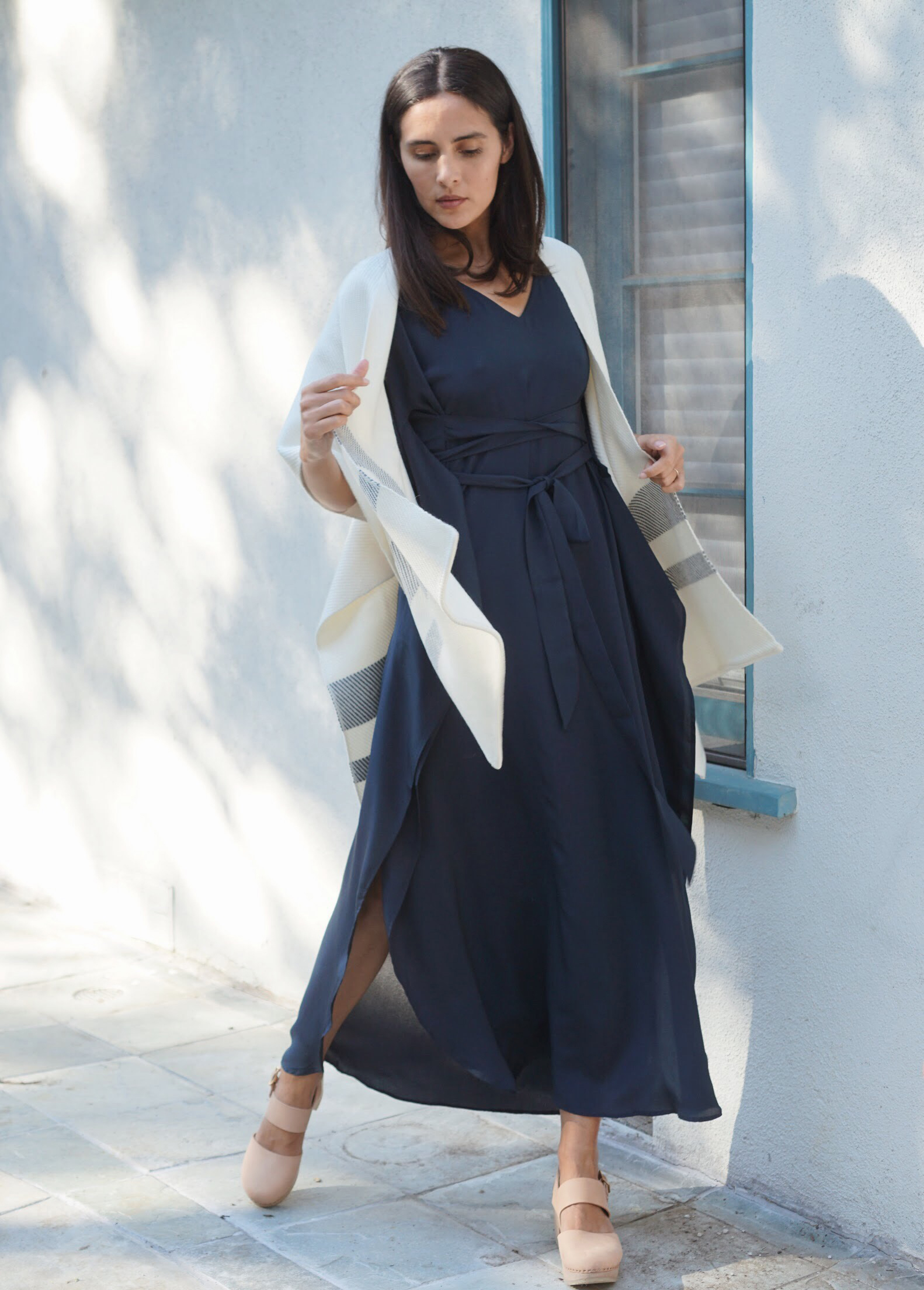 Maiyet Stripe Hem Poncho in Ivory + Raven & Lily Fiza Dress in Navy + Zuzii Close Toe Clogs in Natural.