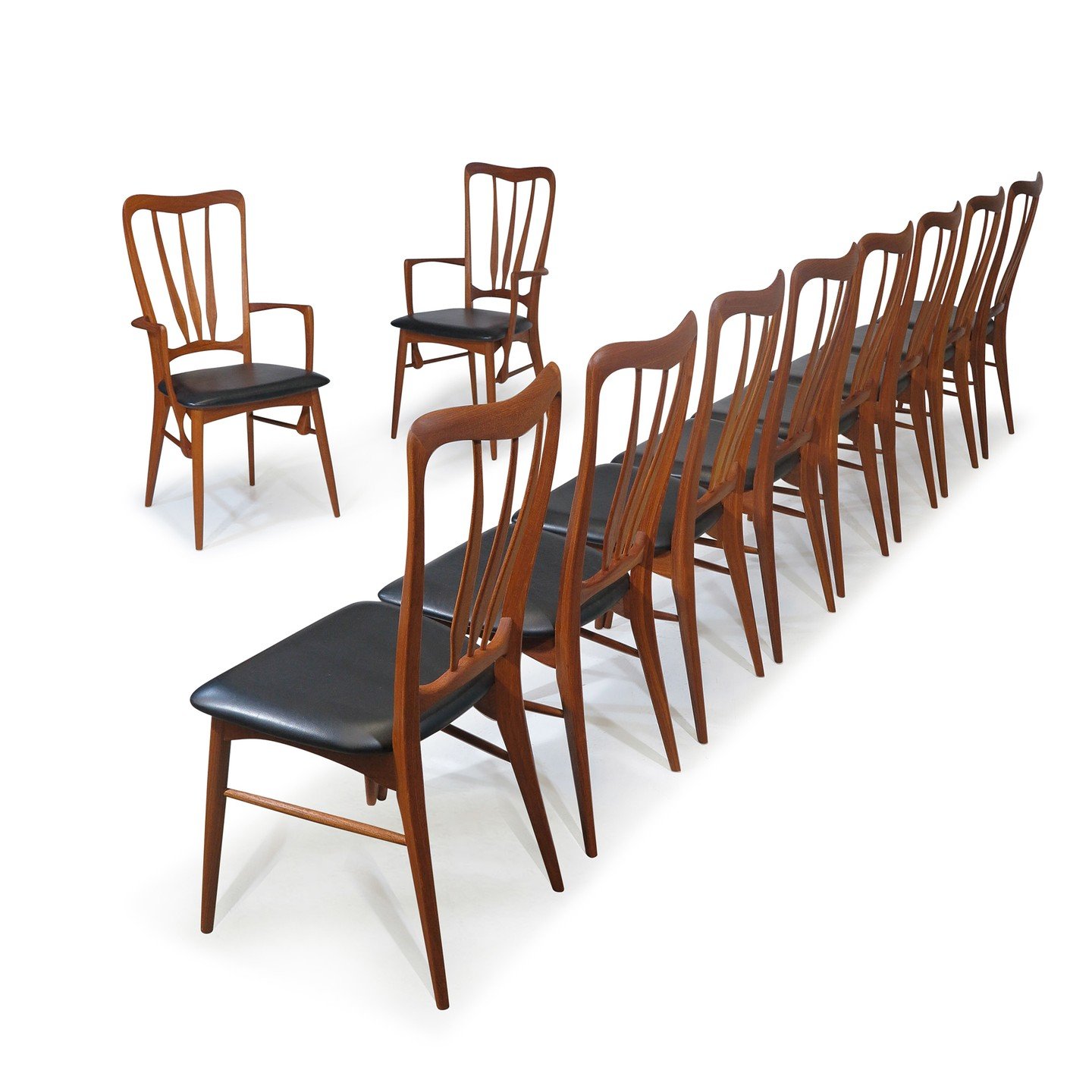 #diningchairs designed by Niels Koefoed for Koefoeds Hornslet, crafted of solid #teak with a #dramatic #sculpted form. The #elegant #scandinavian set includes eight side chairs and two #armchairs , all with original black vinyl upholstered seats.