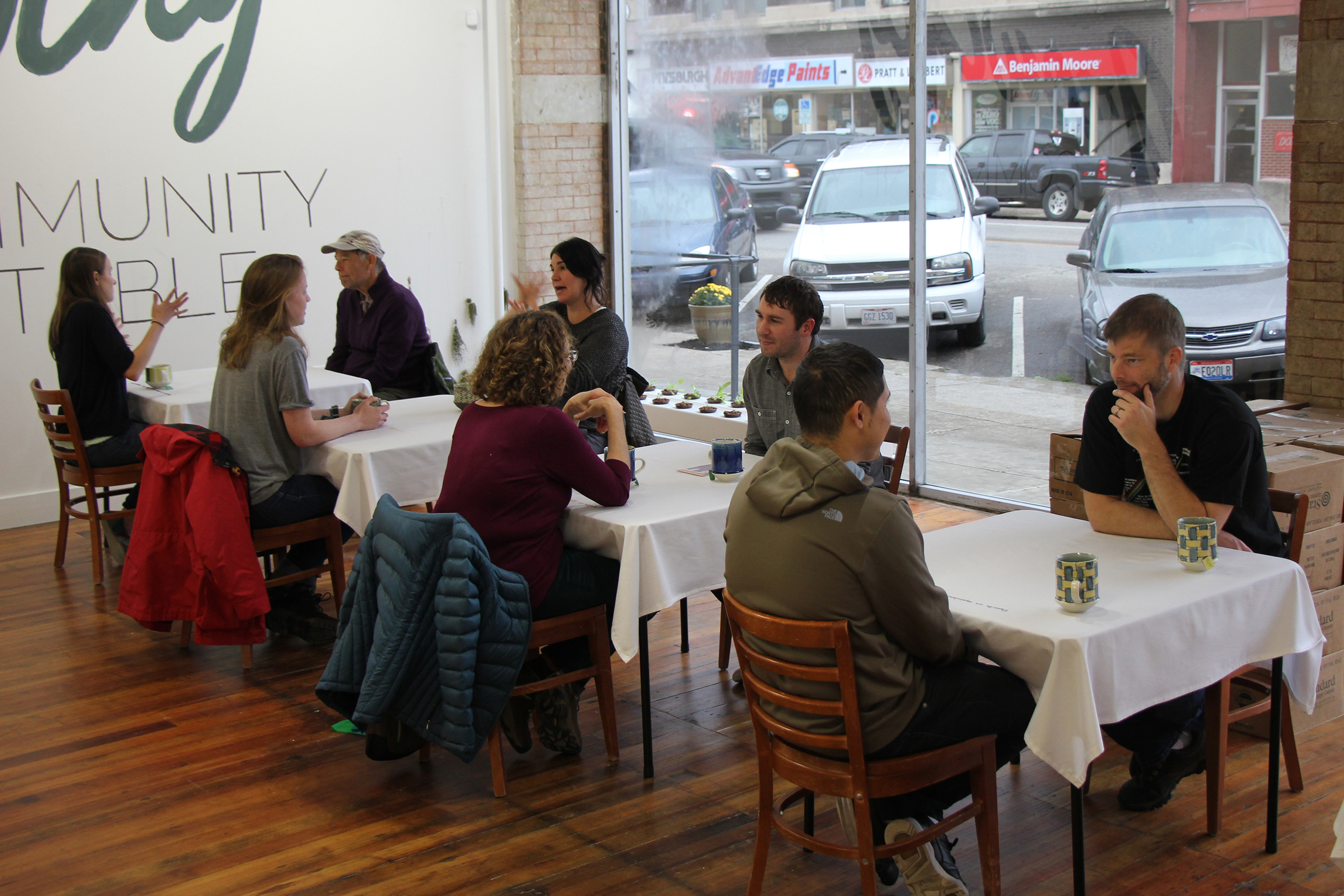  After introducing themselves conversations begin with the most recent prompt embroidered into the table cloth. 