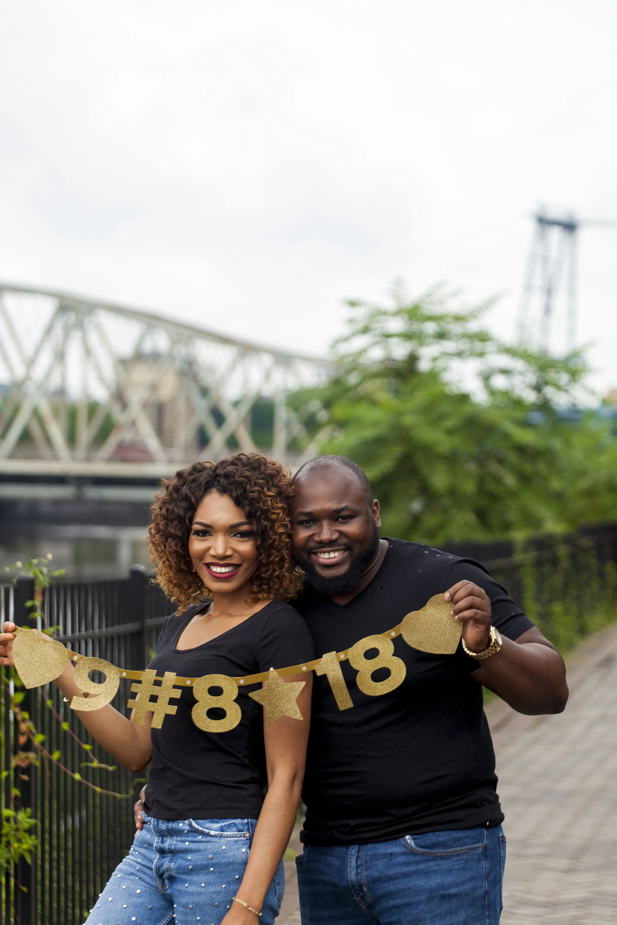 A smiling woman and man holding a gold 