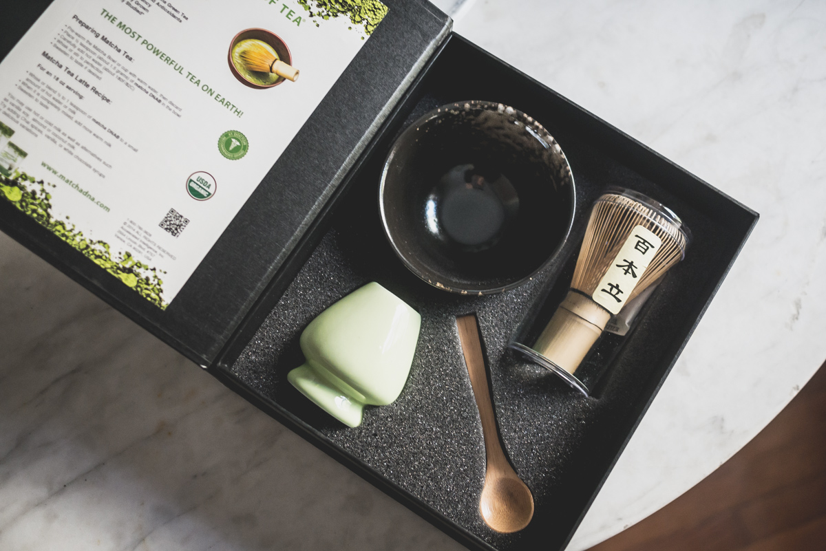 A ceremony matcha tea set includes handmade tea bowl, ceramic whisk holder, bamboo whisk and spoon. 