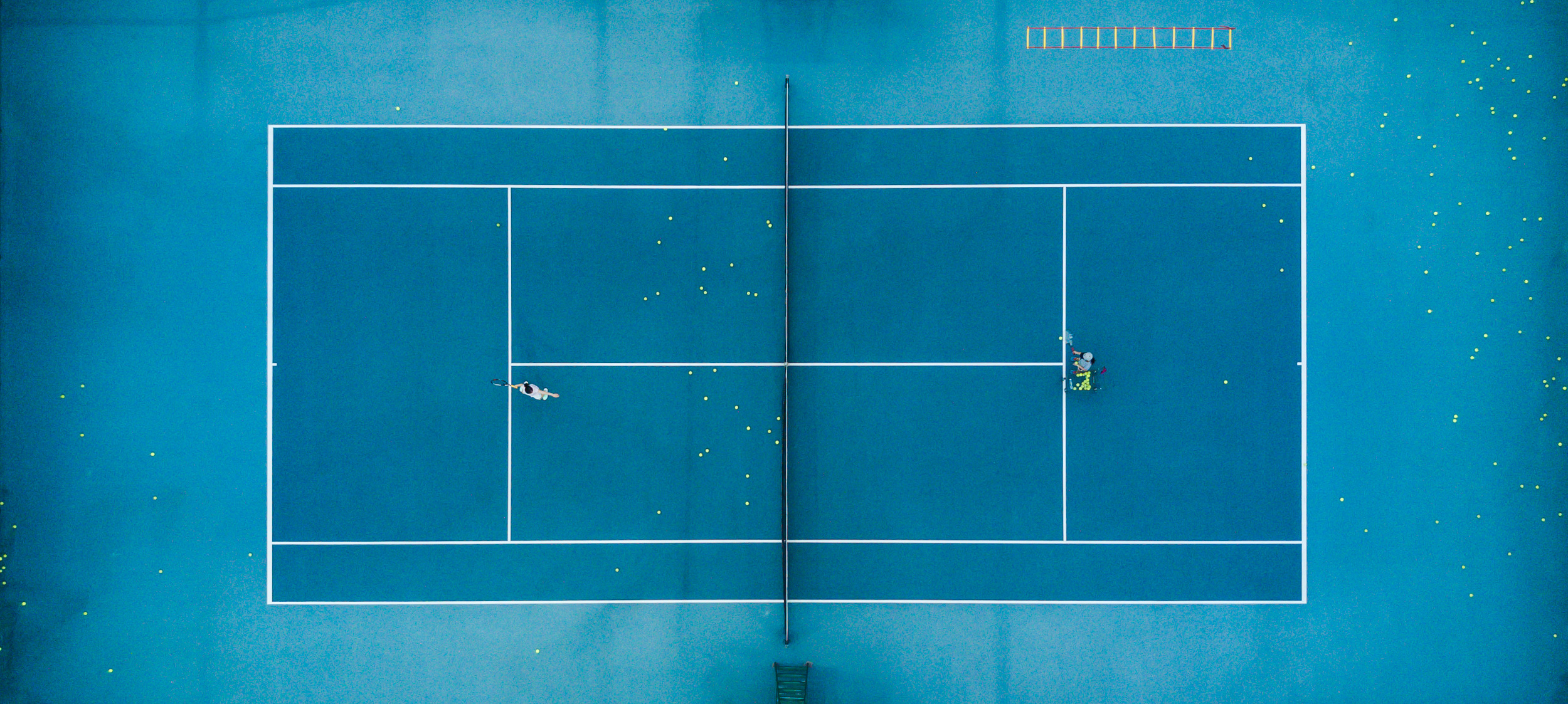 A Tennis player takes time out form the hustle and bustle of City life in China.