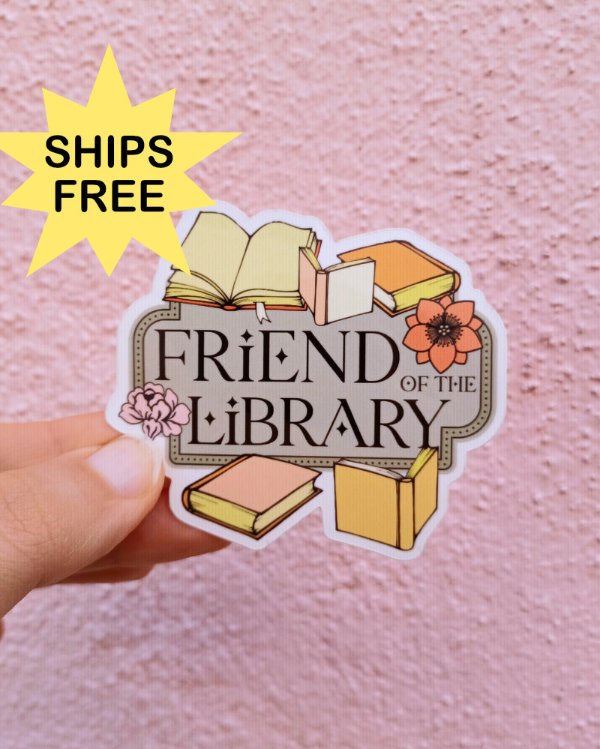 A photo of a white hand holding a sticker in front of a pink wall. The sticker is the text "Friend of the Library" surrounded by books. Text in yellow starburst: SHIPS FREE