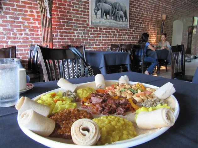 The restaurant space is beautiful, with imagery and posters reflecting life in Ethiopia.