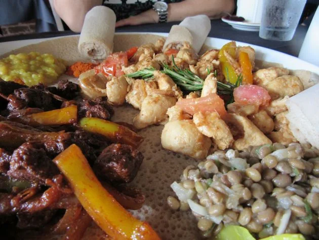 I also loved azifa pictured here in the foreground, a refreshing salad of lentils, onions, jalapeño and lemon juice. In the background are doro tibs, sautéed chicken, and awaze tibs, sautéed beef.