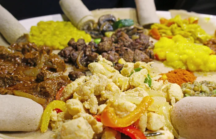 See those rolls on the edges of the plate? This is injera flatbread, which has a spongy texture and a bit of tang much like sourdough bread. No utensils here, use the injera to eat!