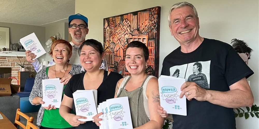 IWC anthology committee members holding the completed anthology