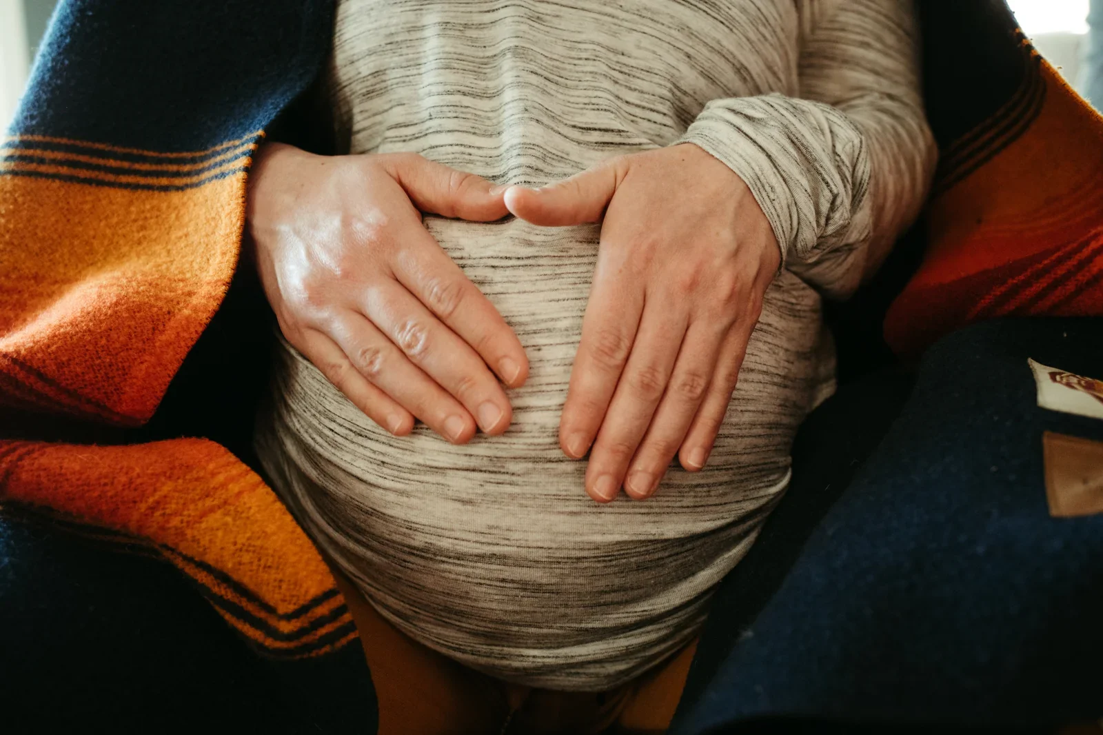 mother holding her belly during session with portland doula.