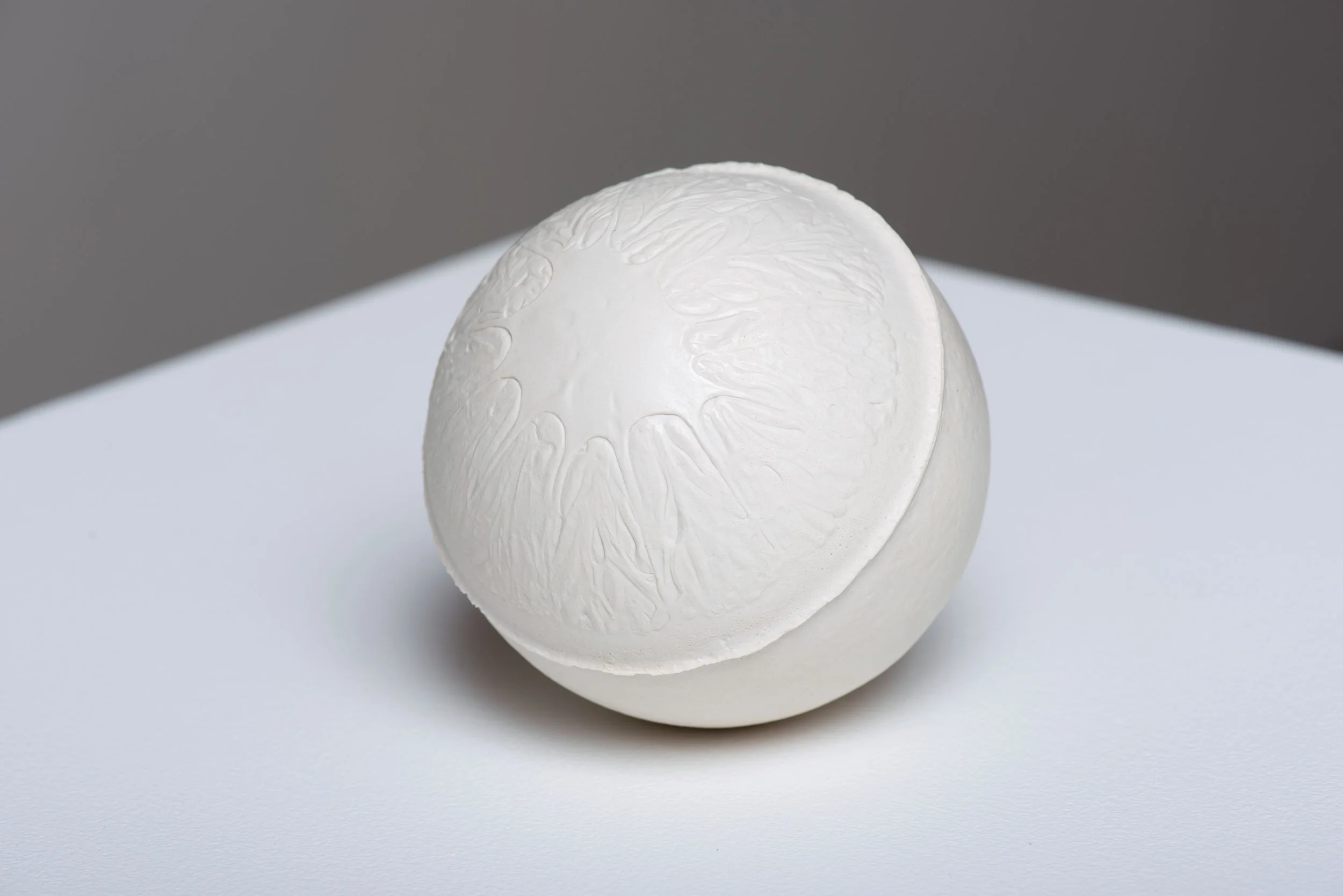 Navel , 2017 Gypsum cement, and porcelain dust 3 1/2 inches (round)