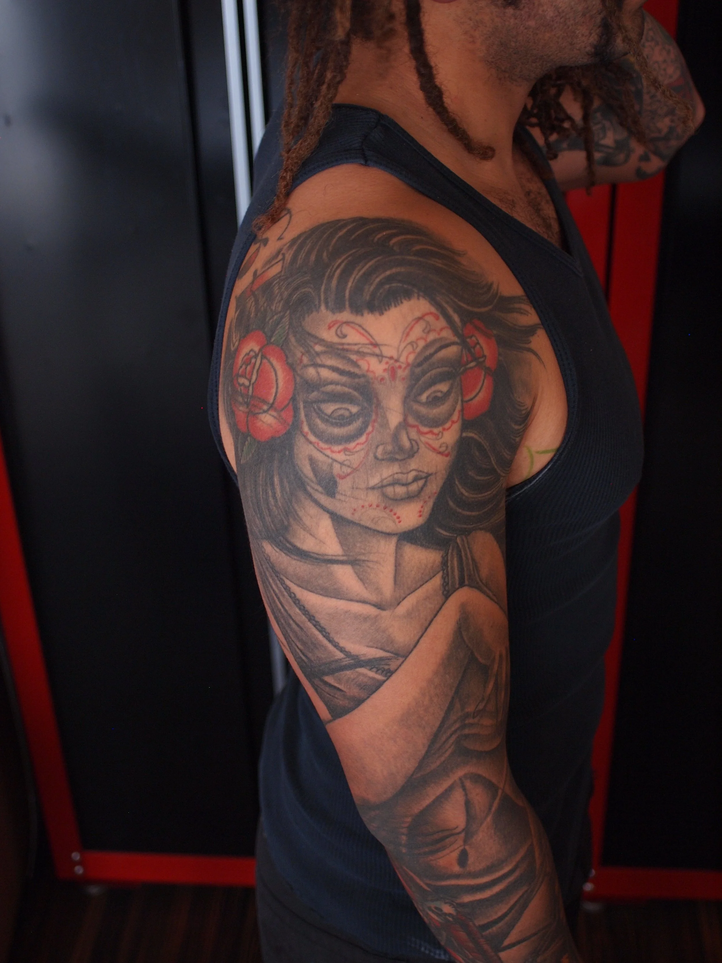 Dia de los muertos black and grey traditional sleeve tattoo by Dominic Vasquez at Superfly Tattoo in San Diego, California