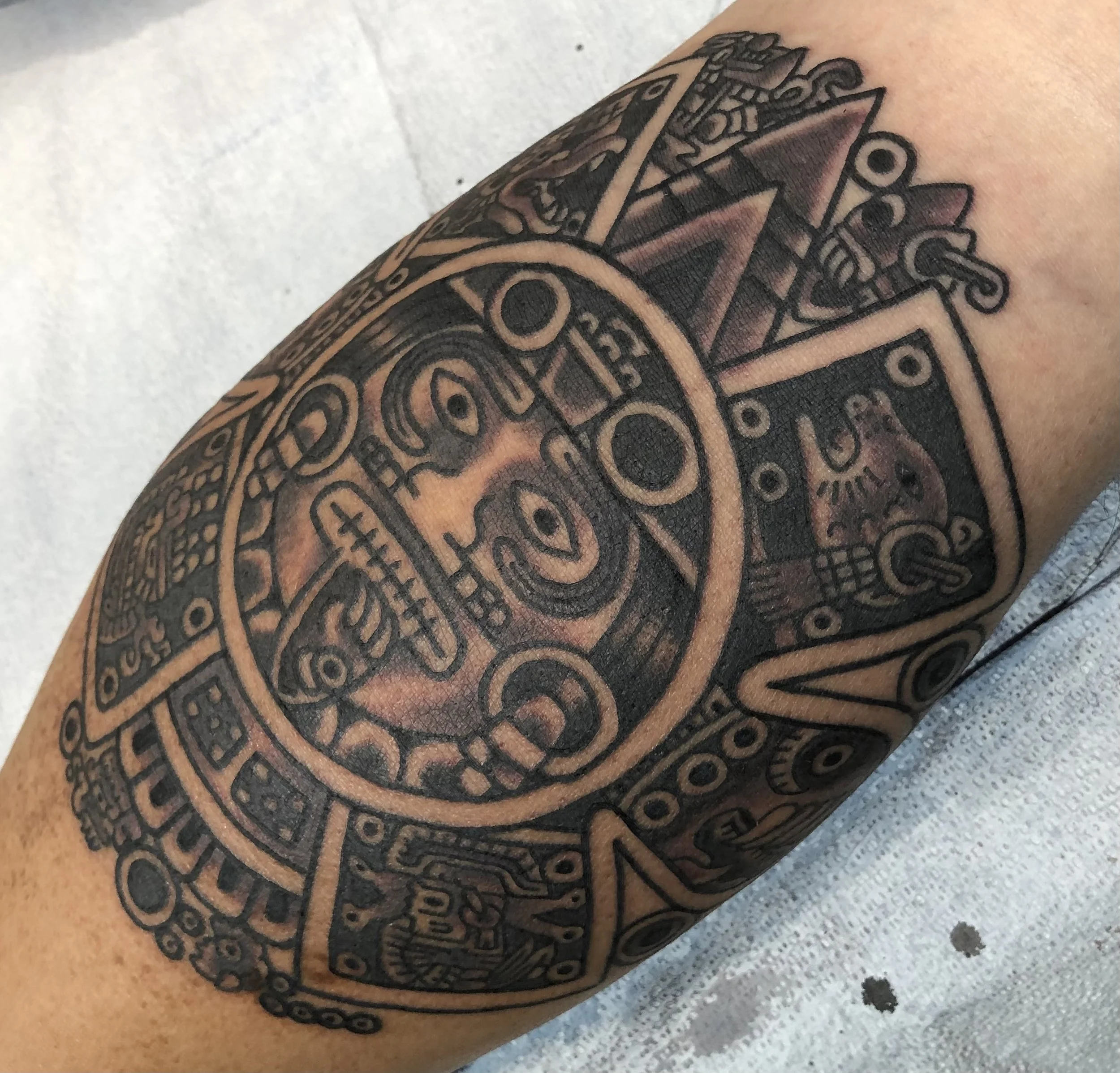 mexica aztec sun tattoo by robert nava at Superfly Tattoo in San Diego, California