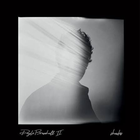 Silhouette of a person with a disturbed, glitchy appearance in a black and white photo.