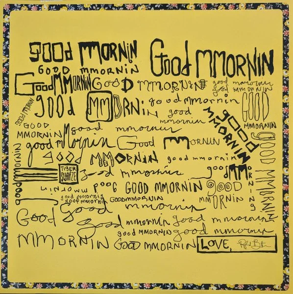 Multiple handwritten variations of the phrase "Good Morning" and "Good Morning" along with the word "Love" inside a box, on a yellow background with a floral border.