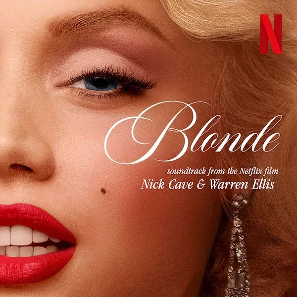 Close-up of a woman's face with bright red lipstick, blonde hair, and a beauty mark, featuring the title "Blonde" and text about the soundtrack from the Netflix film by Nick Cave and Warren Ellis. A red Netflix logo in the top right corner.