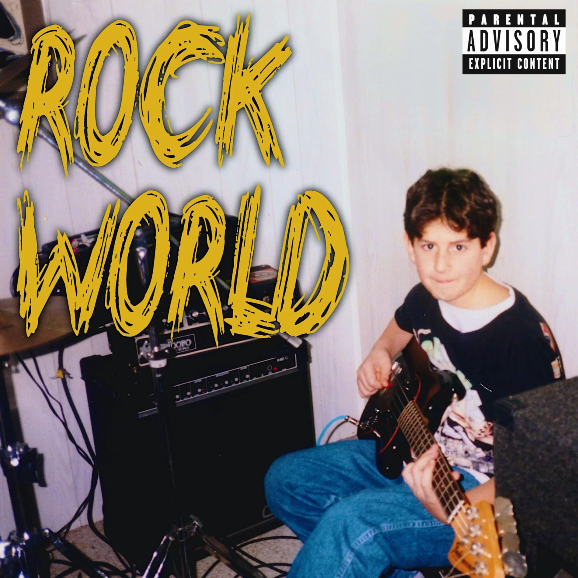 A young boy with brown hair wearing a black t-shirt and floral shorts sitting on a blue chair, playing an electric guitar. He is in a room with white paneled walls and a black amplifier, surrounded by guitar equipment and cables. There is a large, yellow, graffiti-style text overlay that reads "ROCK WORLD" and a parental advisory label in the top right corner.