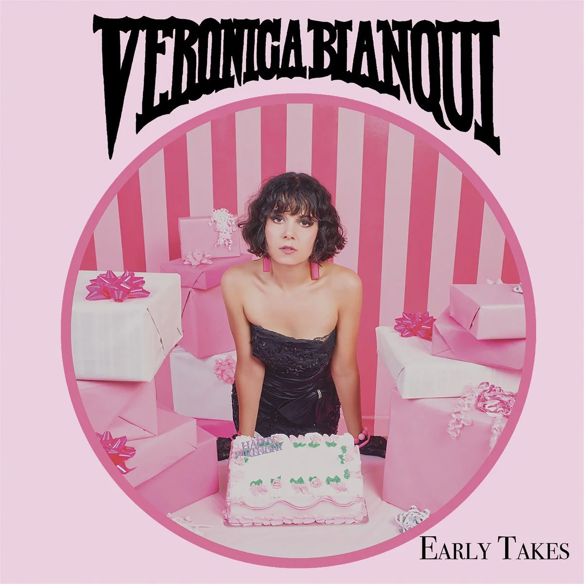 A woman with curly short hair and pink earrings stands behind a pink birthday cake with "Happy Birthday" written on it, surrounded by pink and white wrapped presents with bows, in a pink-striped room. The image is the cover art for an album titled "Veronica Beatriz" by the artist "Early Takes."