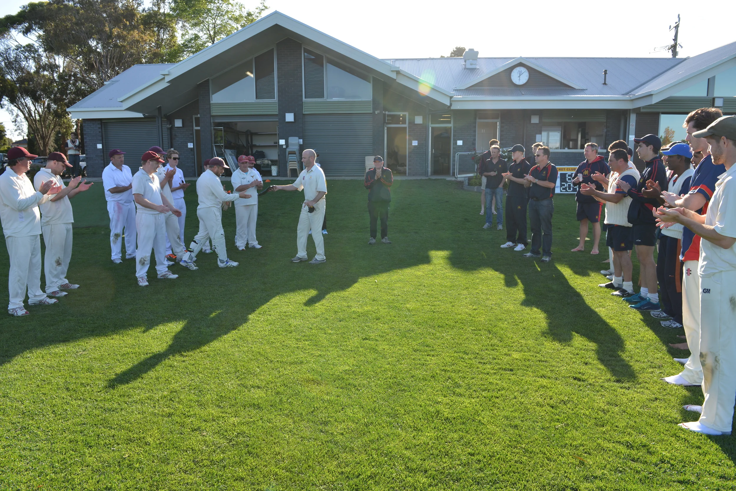 Mont Albert Captain and Marcellin Old Boy, Greg Cull, passes Marcellin Captain Paul Dinneen the John O'Loughlin Trophy