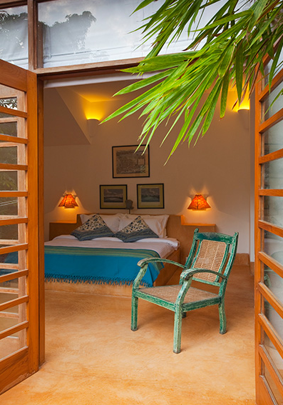 Open air doors allow for a breezy bedroom | EAT.PRAY.MOVE Retreats | Goa, India