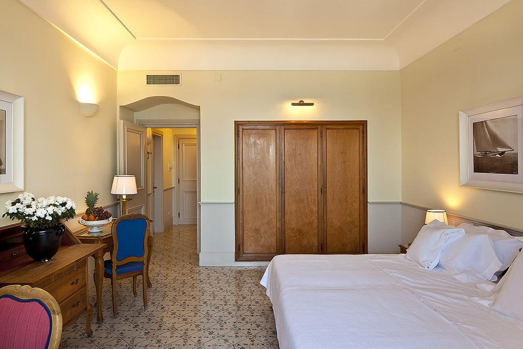 Guest room with tiled floor and balcony | EAT.PRAY.MOVE Yoga Retreats | Ischia, Italy