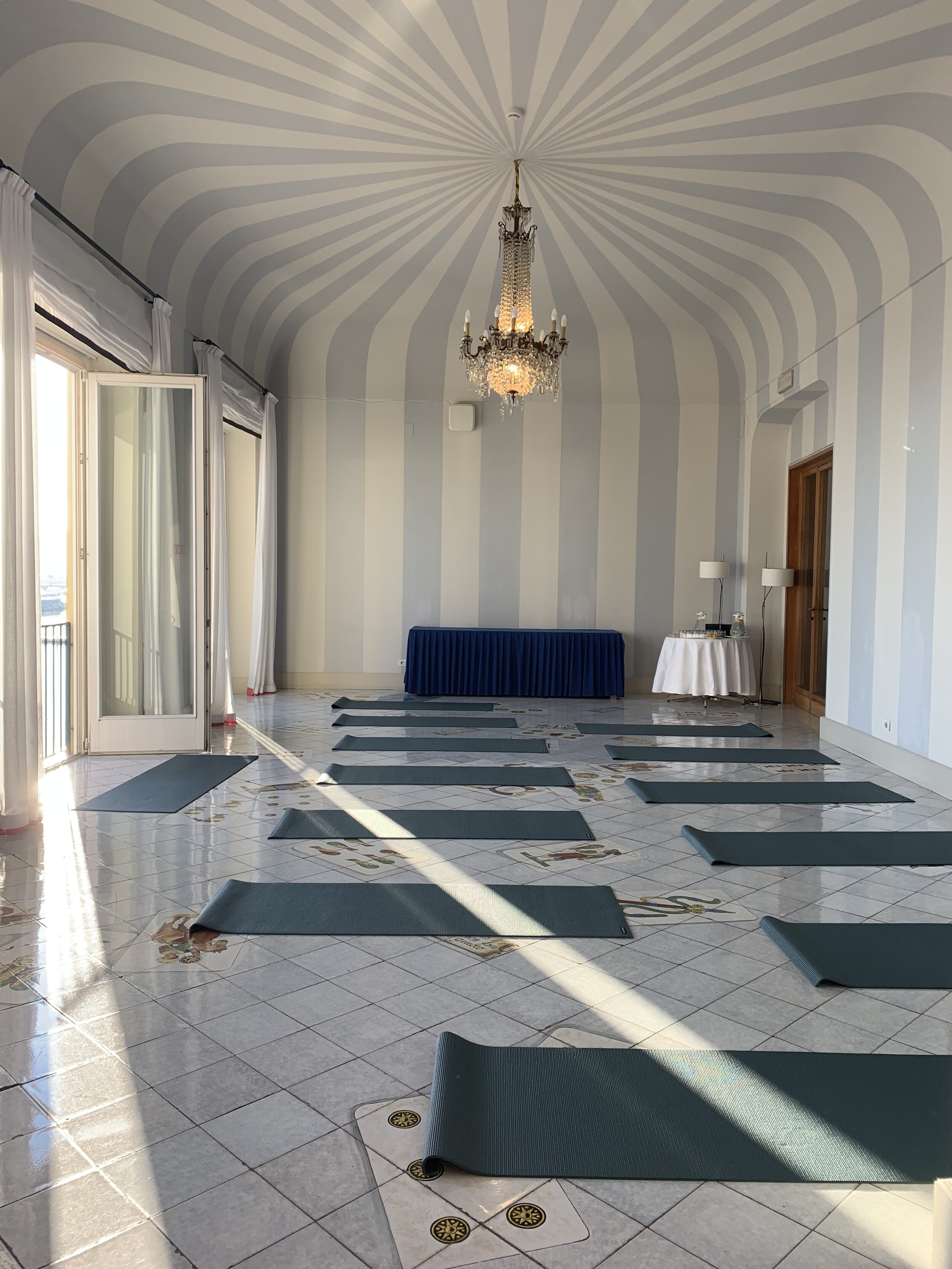 Striped walls and chandeliers in the yoga room | EAT.PRAY.MOVE Yoga Retreats | Ischia, Italy