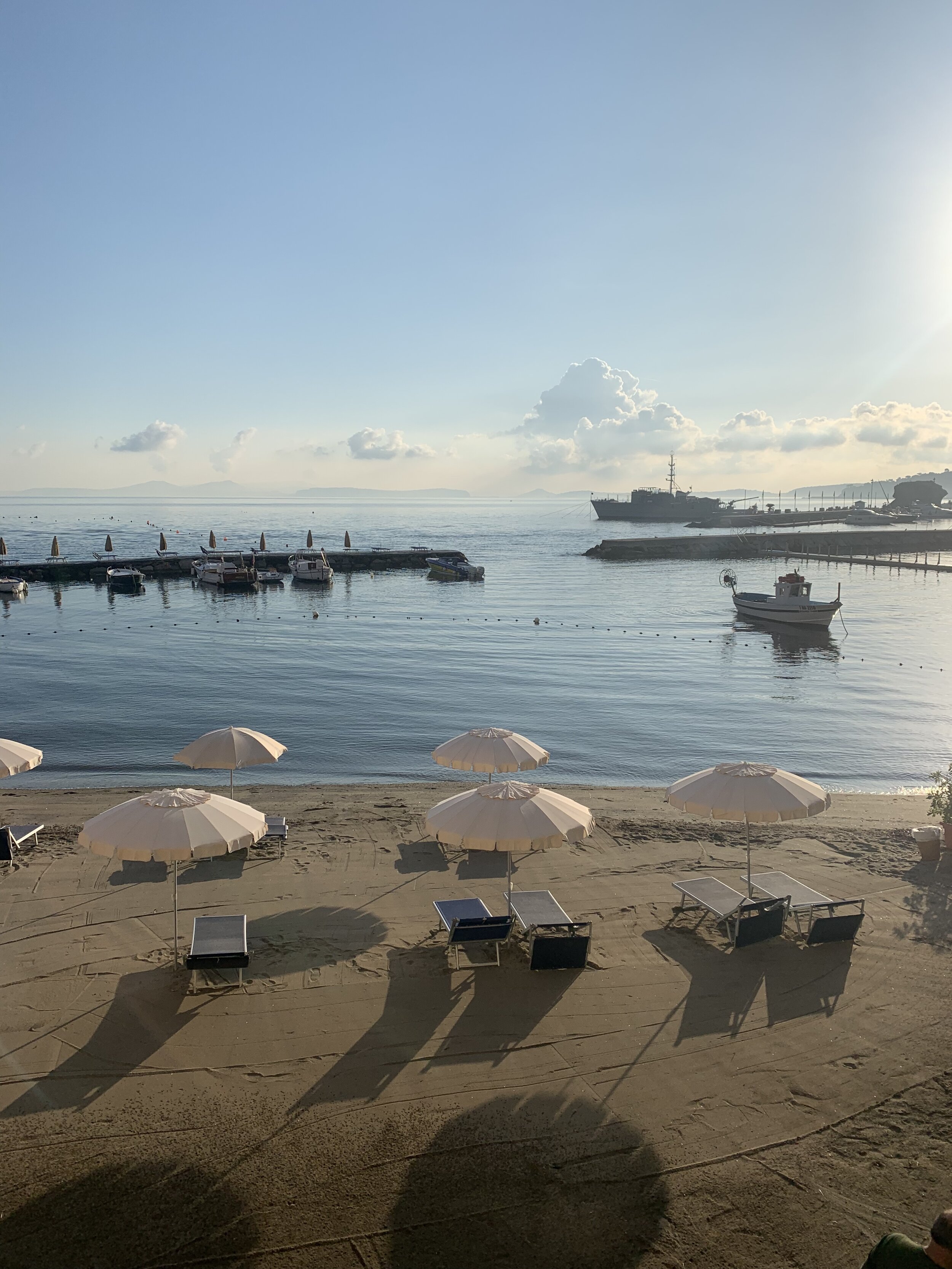 White umbrellas on the dock | EAT.PRAY.MOVE Yoga Retreats | Ischia, Italy