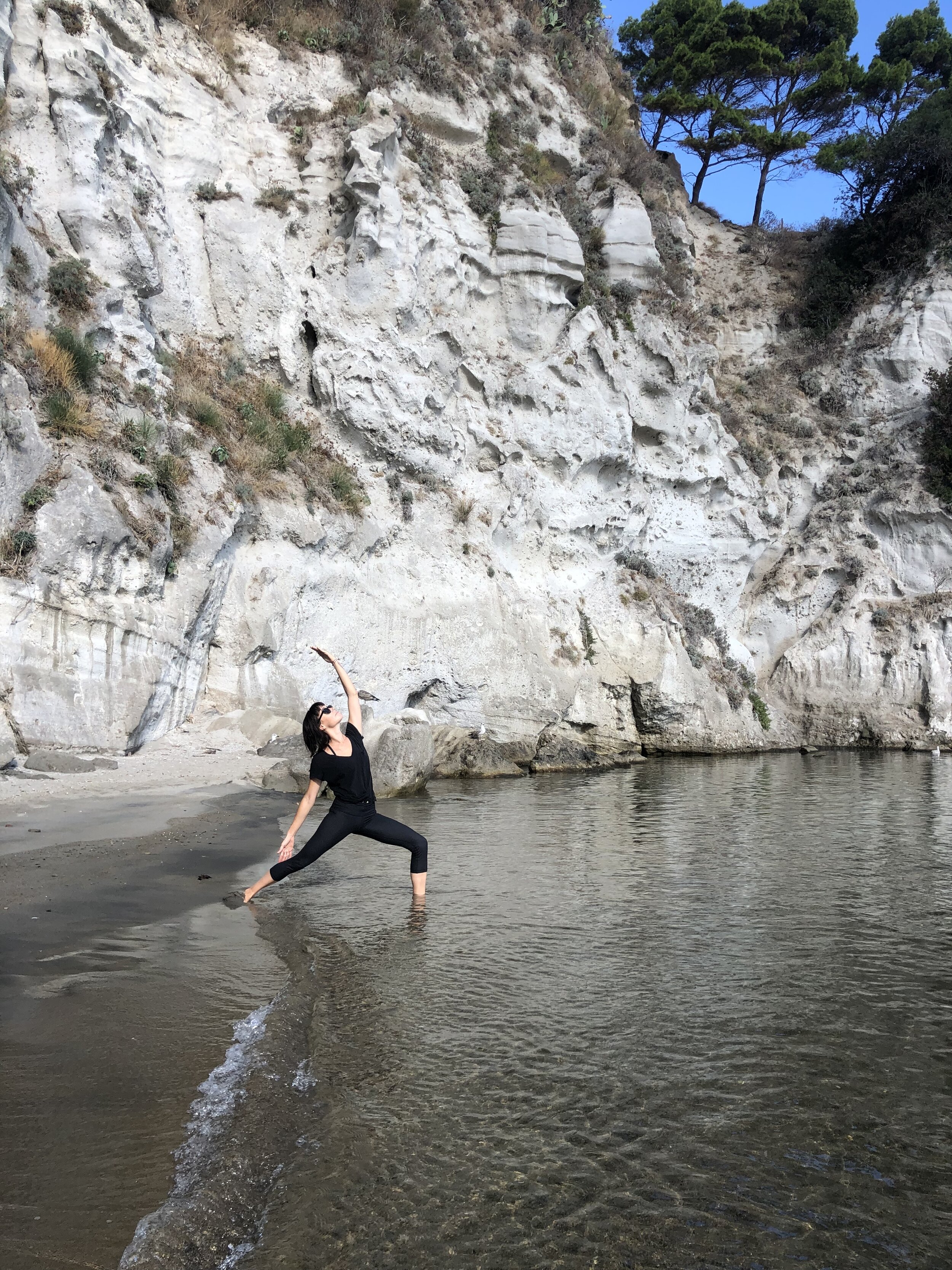 Dancing warrior in the water | EAT.PRAY.MOVE Yoga Retreats | Ischia, Italy