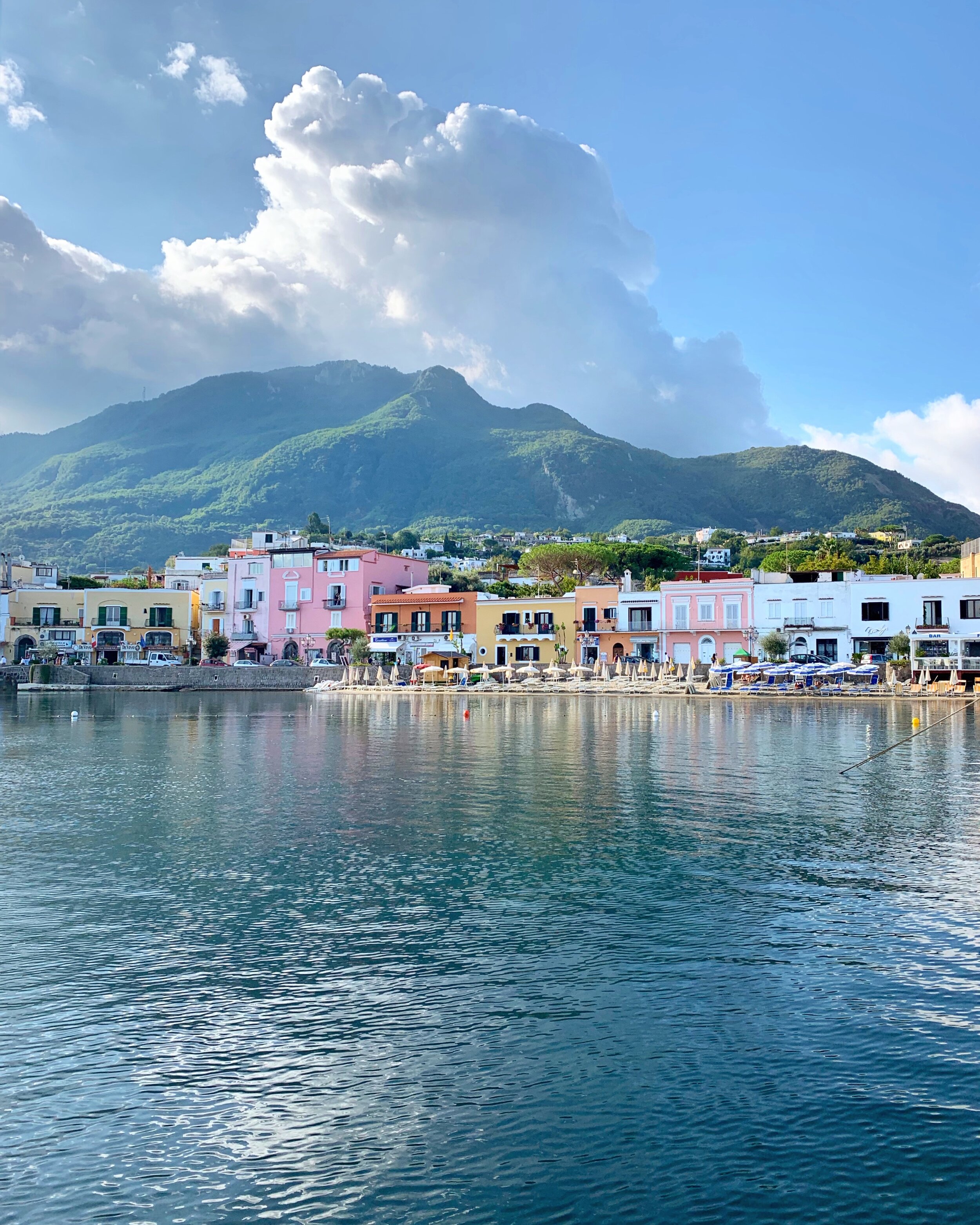 Reflections of pastel houses in the water | EAT.PRAY.MOVE Yoga Retreats | Ischia, Italy