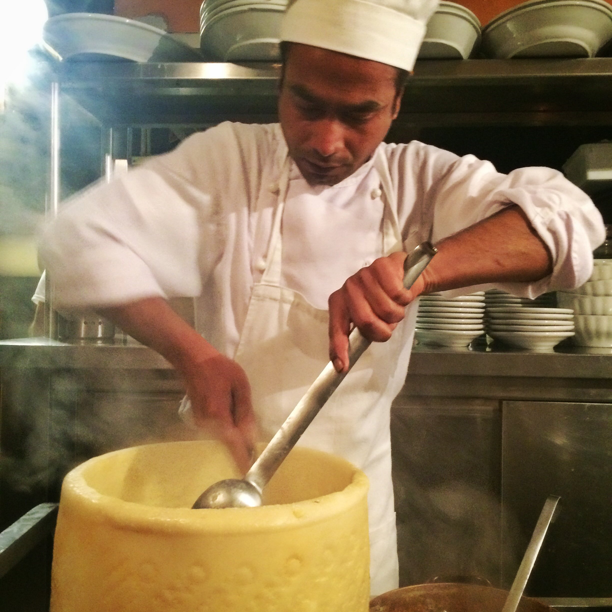 Pasta thrown into a wheel of Parmesan | EAT.PRAY.MOVE Retreats | Venice, Italy 