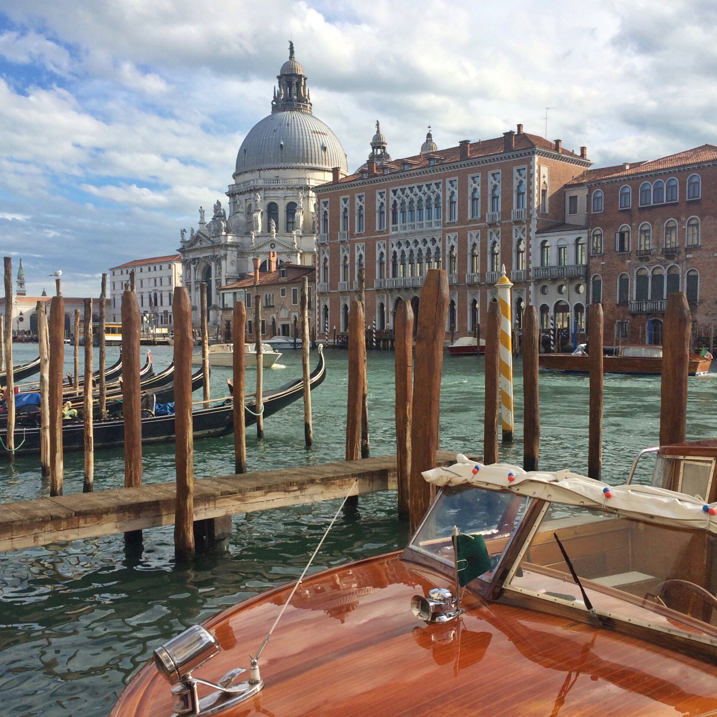 A parked boat in the teal waters | EAT.PRAY.MOVE Retreats | Venice, Italy 