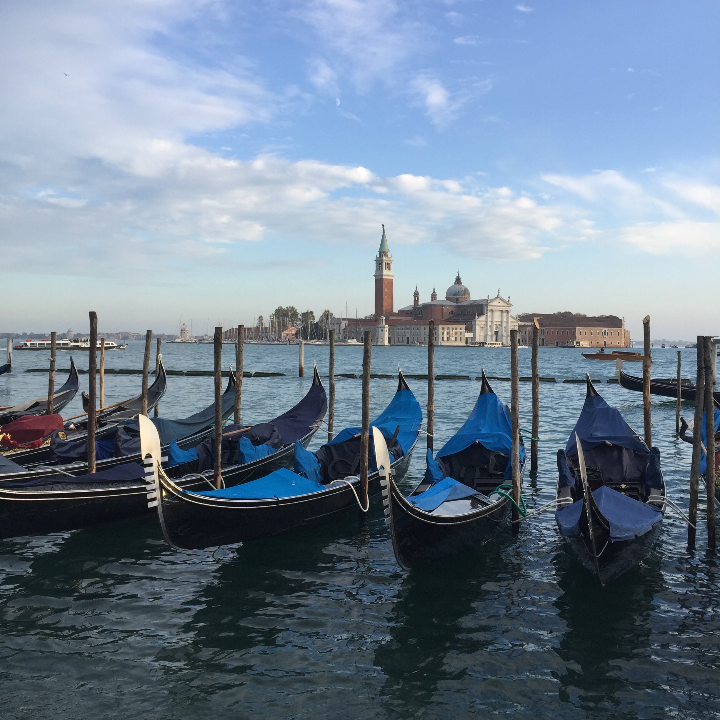 A lineup of gondolas | EAT.PRAY.MOVE Retreats | Venice, Italy 