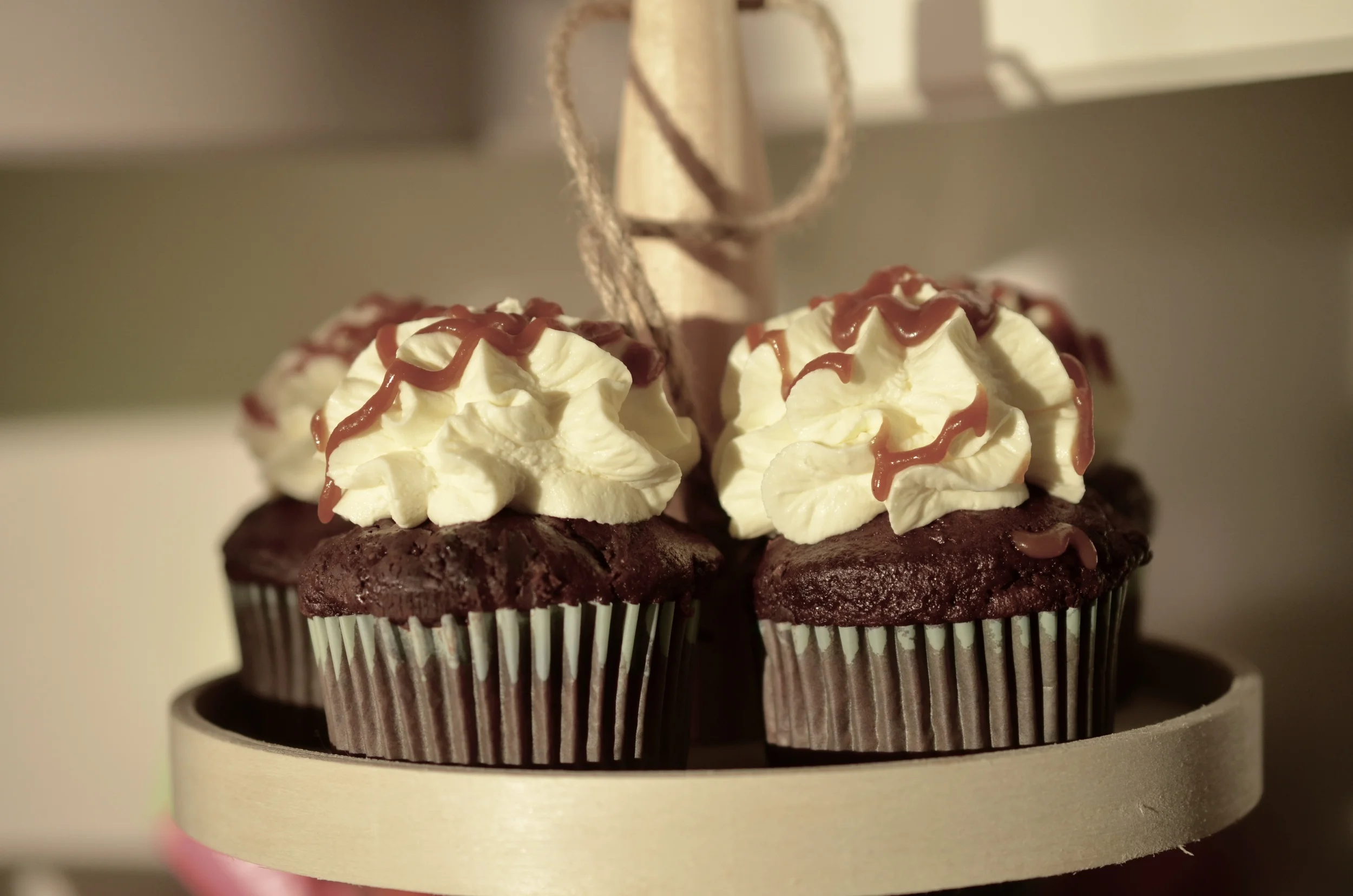Double chocolate and banana cupcakes topped with Mascarpone cream and Rum caramel sauce