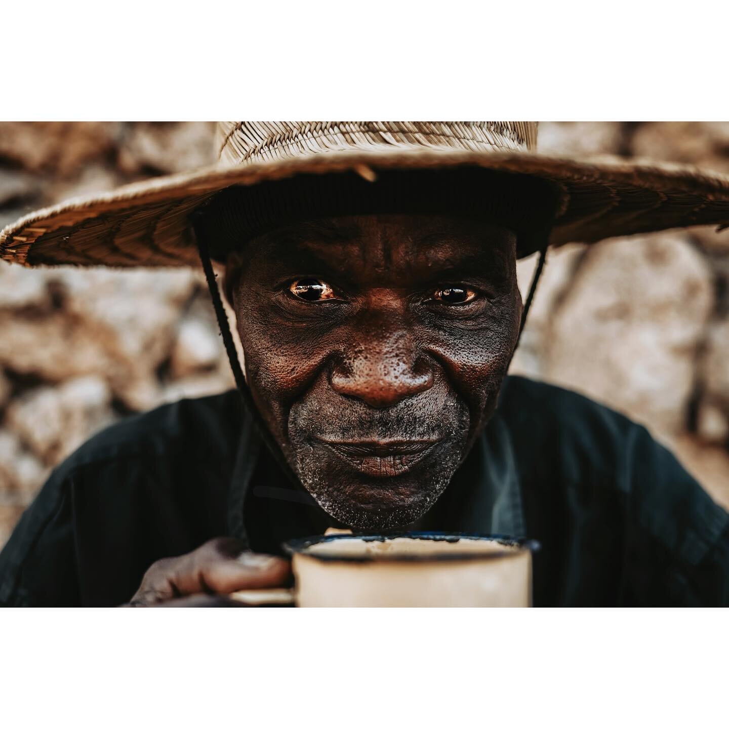 Baba Mzee sipping chai tea &bull; One of my favorite, unexpected things about each time I return to my Turkana friends are the small pieces of past trips. Small tokens of previous memories with friends. For example, the straw hat Baba Mzee is wearing