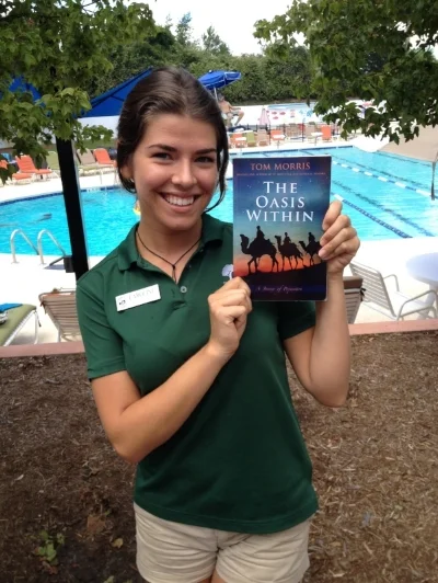 Singer Caroline Klehr with The Oasis Within , a bit of summer reading on a warm sunny day, poolside.