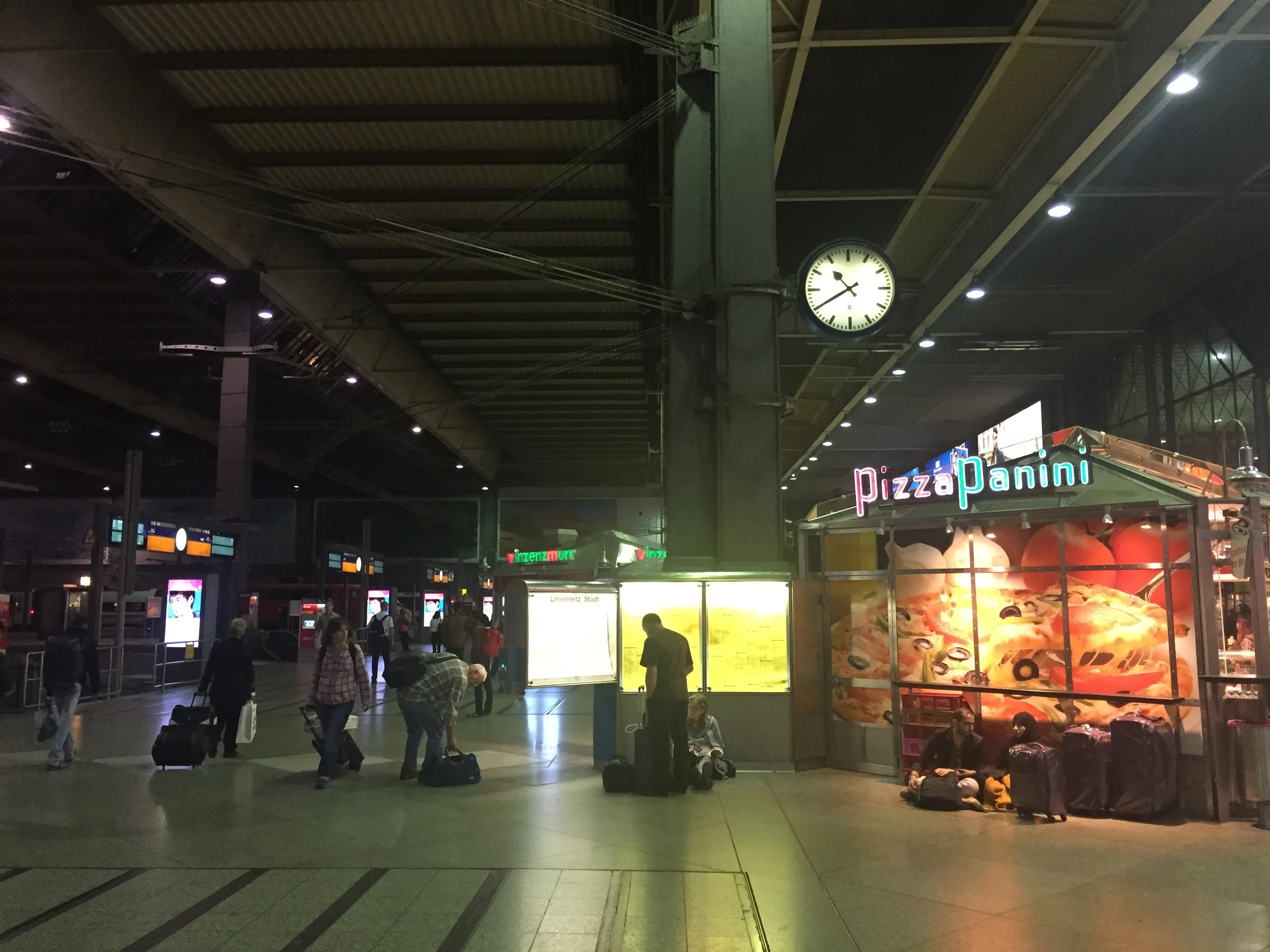 The main area just off the platforms in Munich. They yellow board is the list of all departures for the day from the station. The couple underneath the board is who made the comment about kid's missing their train. 