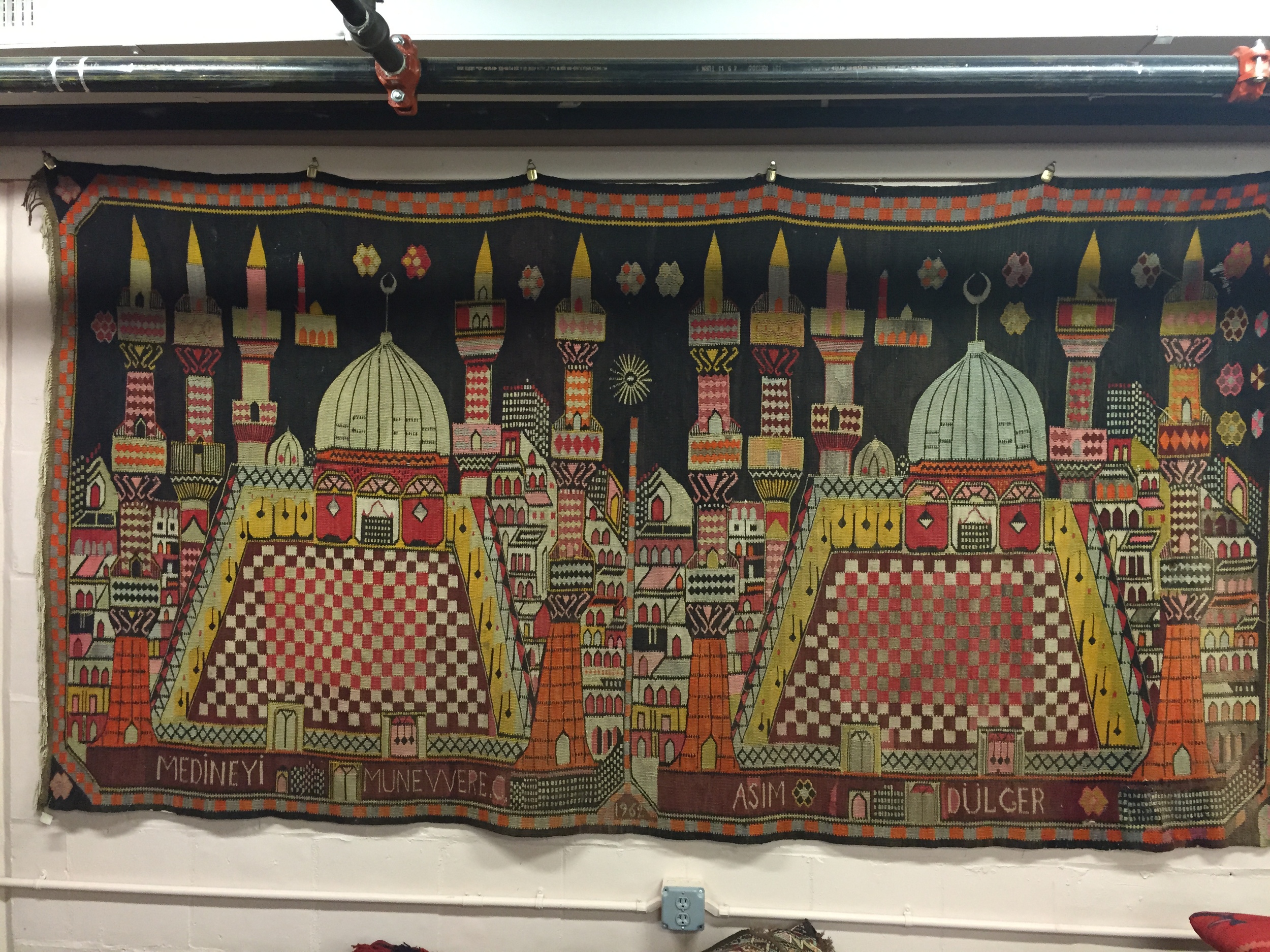 Kilim dated 1962, depicting the Grand Mosque at Mecca. It commemorates a family member's pilgrimage. 10ft x 5ft2in