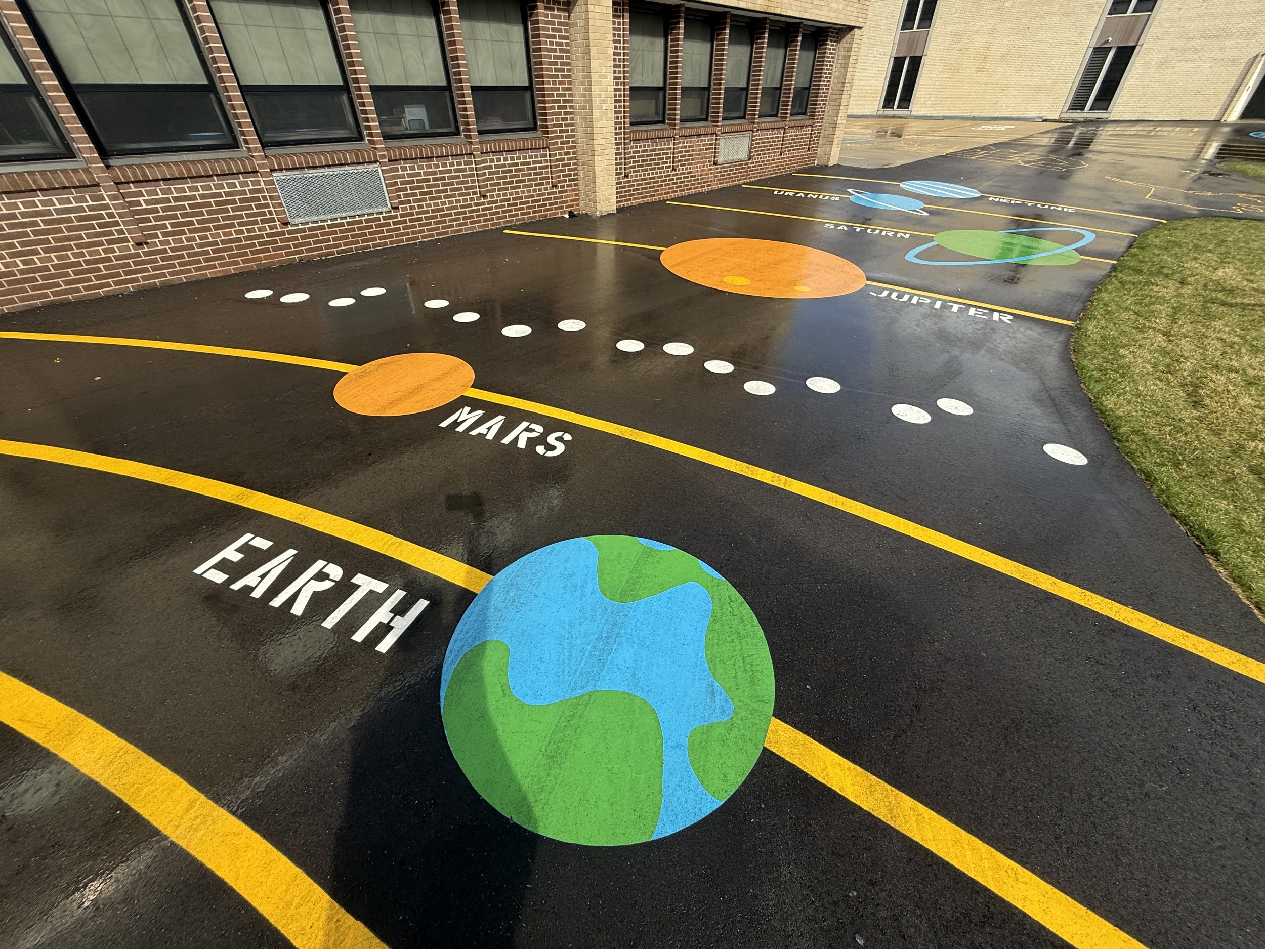 Creative asphalt painting depicting the solar system