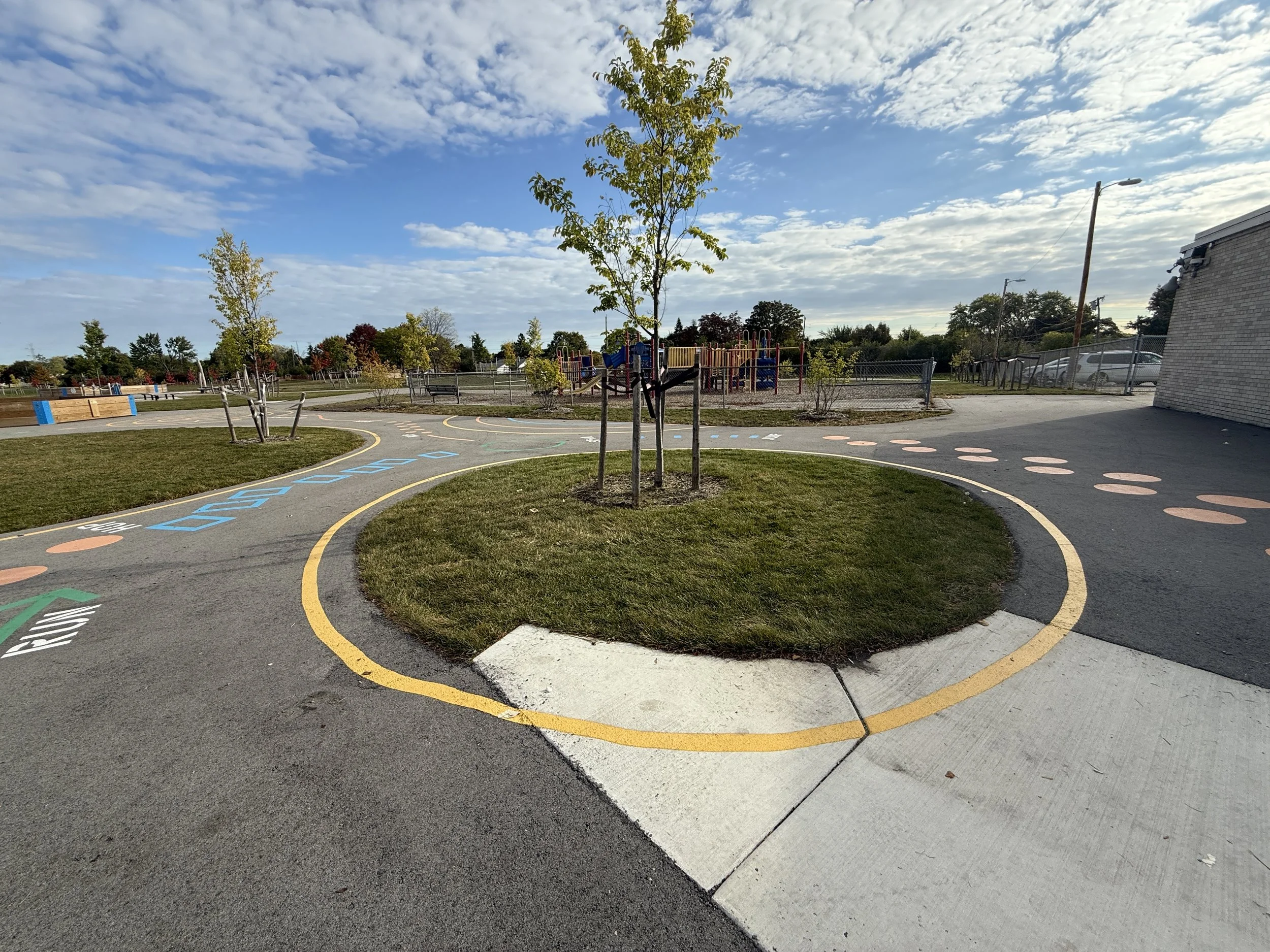 Painted play markings, grass areas and trees for shade and stormwater management