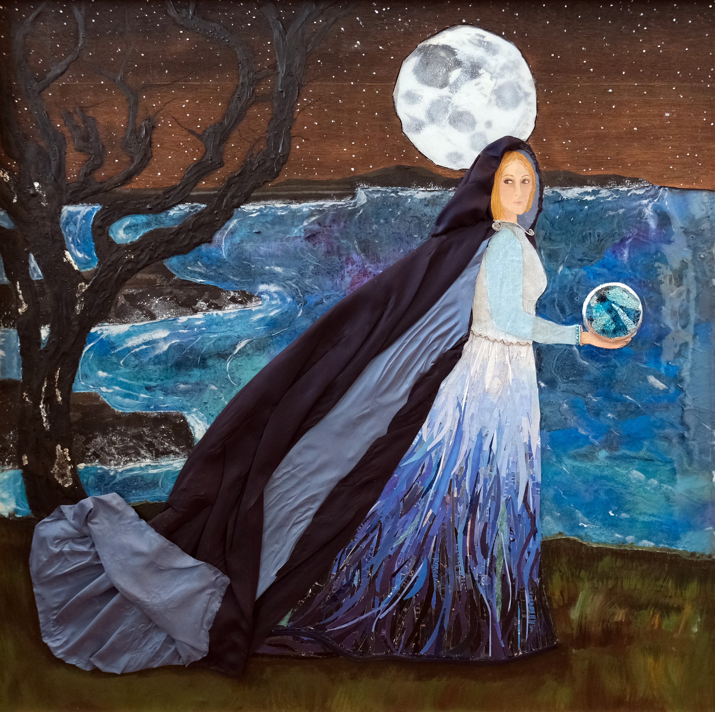 cloaked welsh goddess stands on the cliffs edge holding the silver wheel under a full moon surrounded by the motion of the ocean