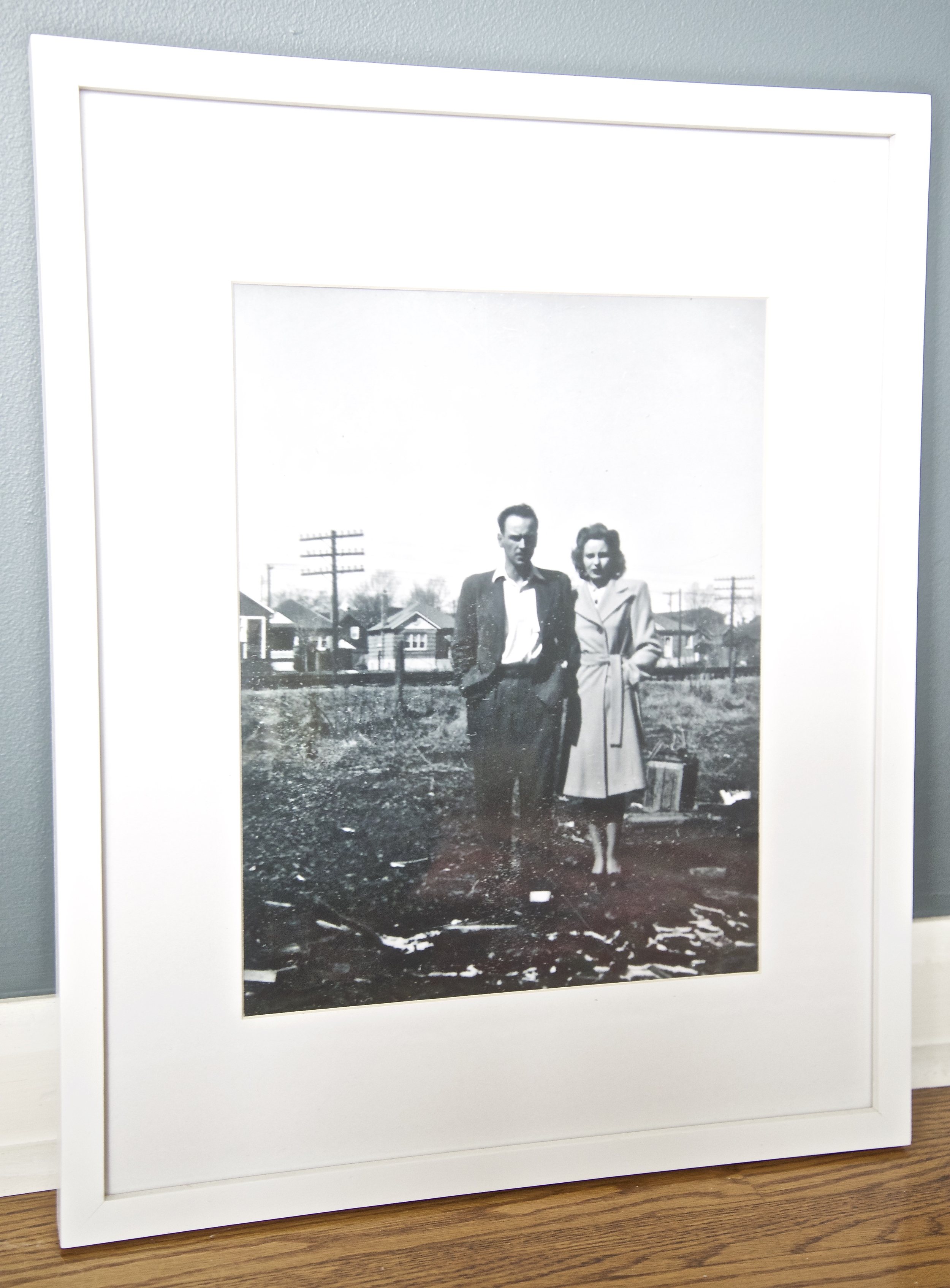 This black & white photograph is a portrait of my grandparents. My husband surprised me & had it blown up from the original copy. To say I love it would be an understatement! The placement of the poles in the background adds to the street scene behind them.