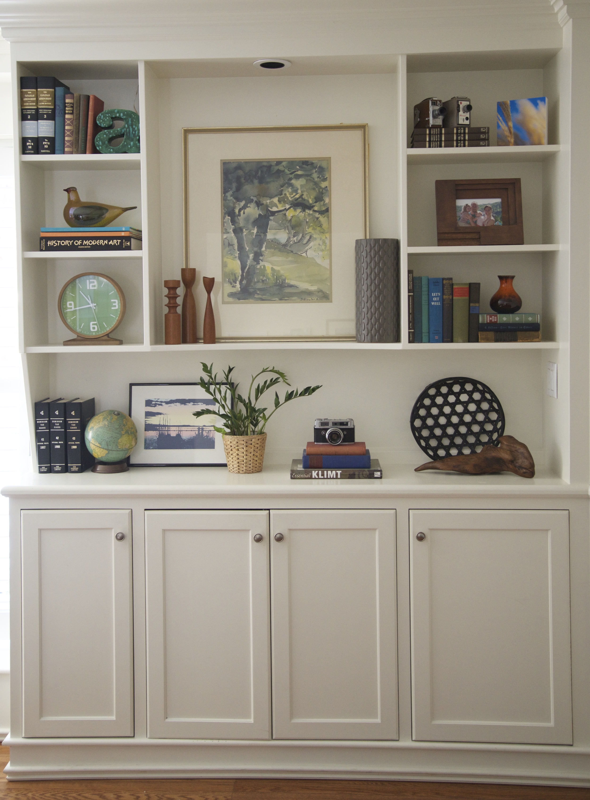 These cupboards are hiding books, toys, games & camera equipment. Thank you to the previous home owners for ditching the fireplace and replacing it with built-ins!