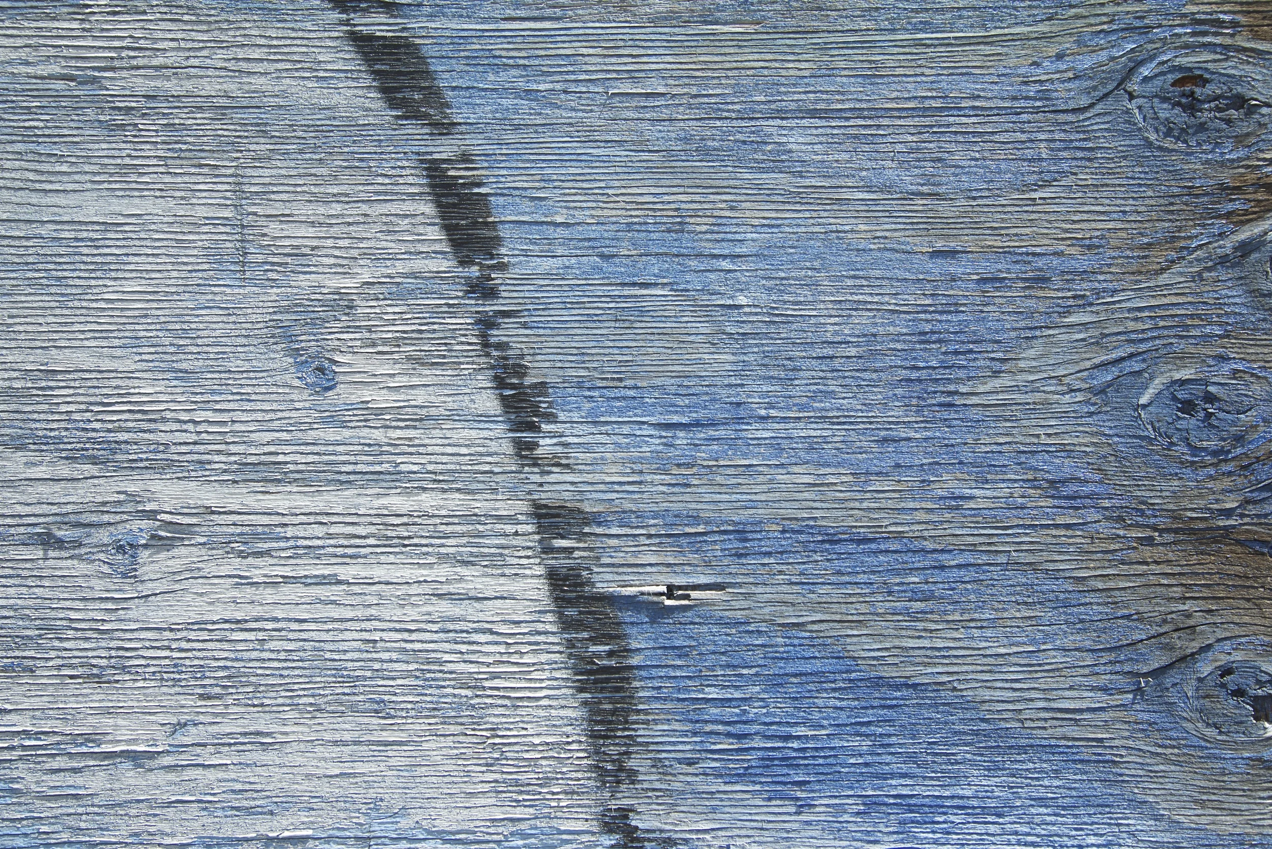 This is on a large scale wall downtown that has graffiti on it. I always drive by and recently decided to get out of my car and take a closer look. The actual images that were painted did nothing for me, but the fact that the paint also went onto this piece of wood were delightful.