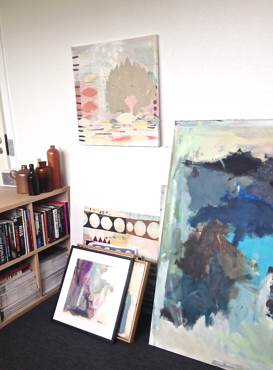 Stacks of original artwork and a collection of pottery...dreamy!