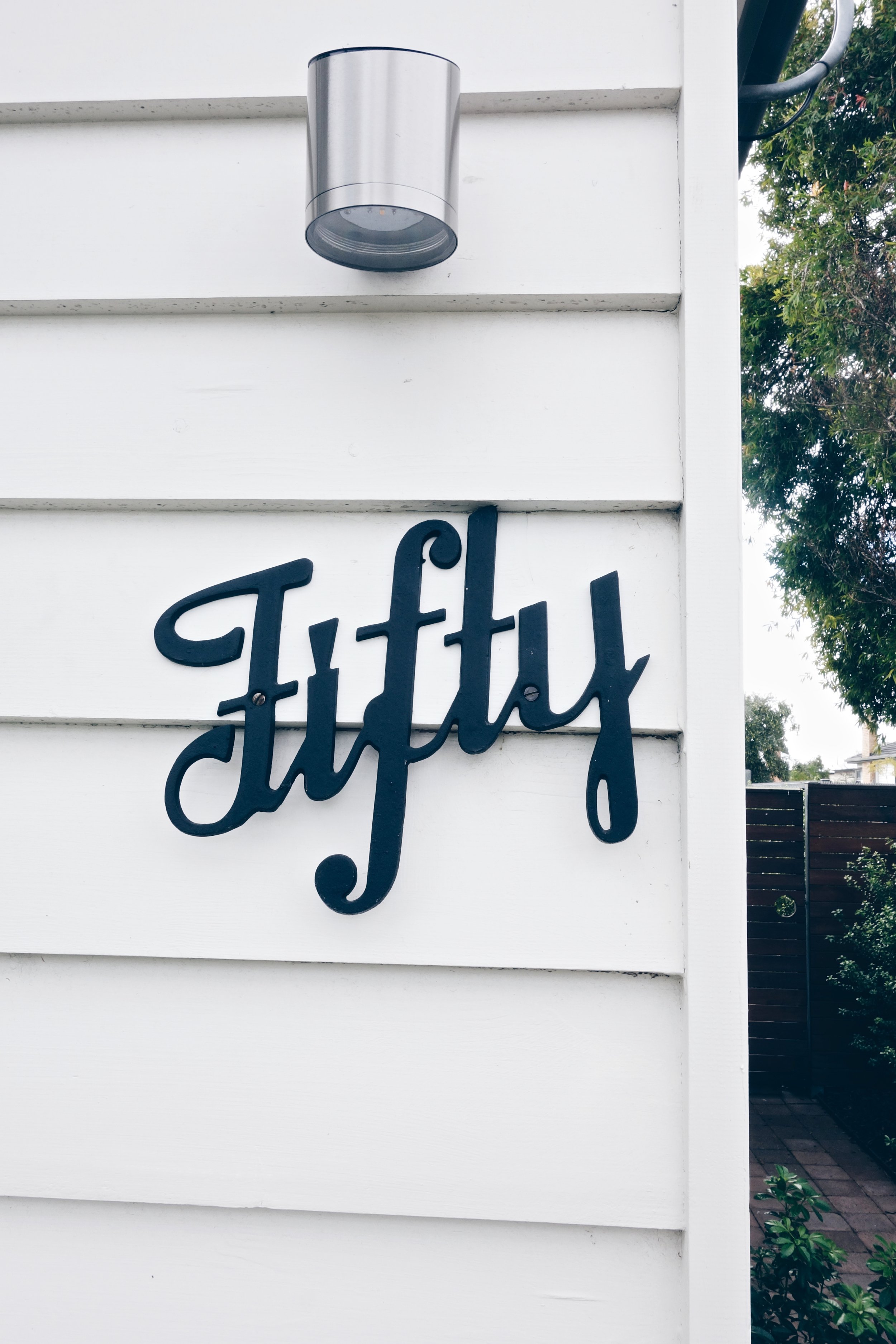 I love this house number, it's got a vintage quality that stands out against the white siding.
