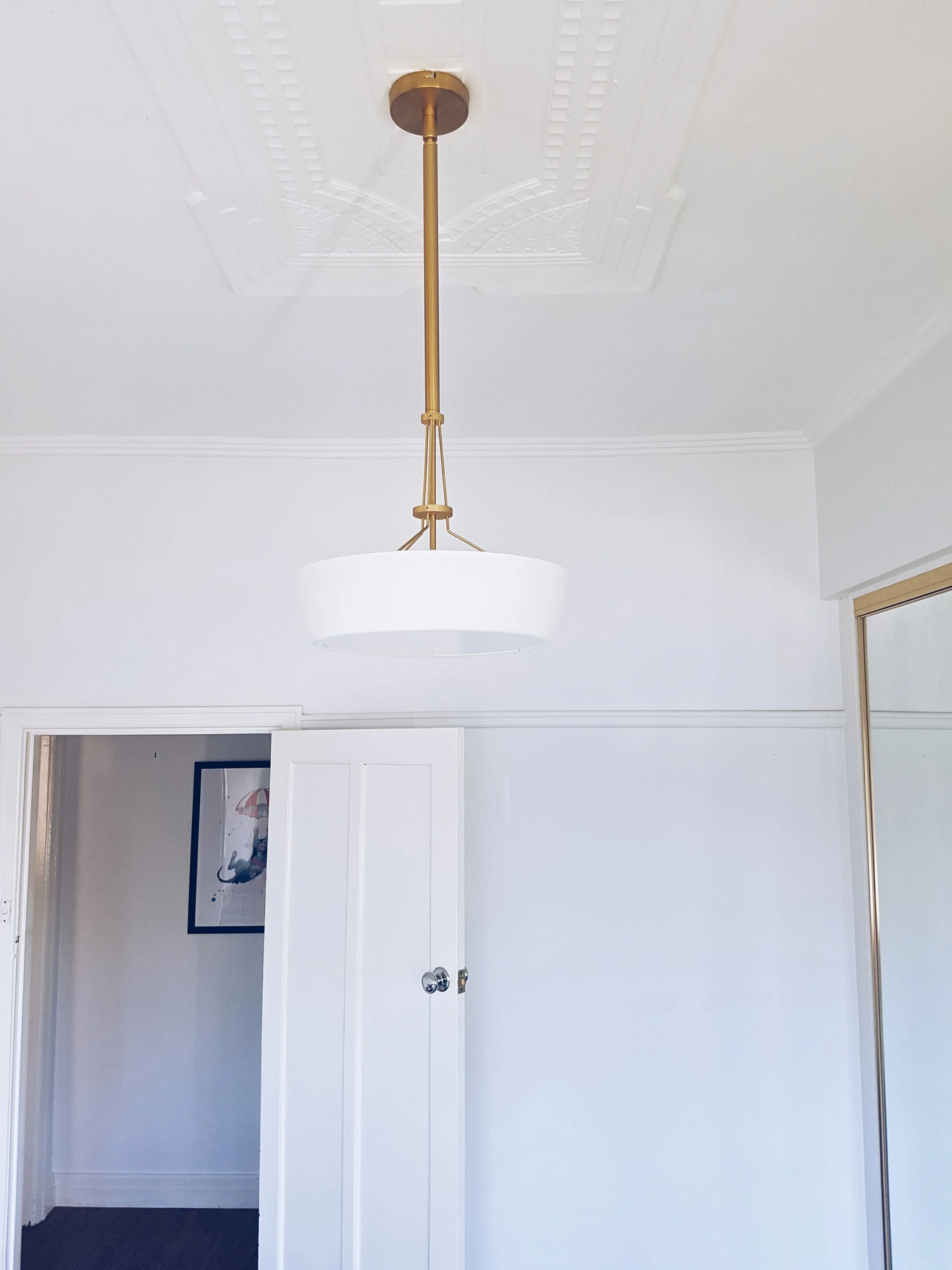 "I replaced the pendant light with a brass art deco pendant that took months to track down, creating a sense of nostalgia." 