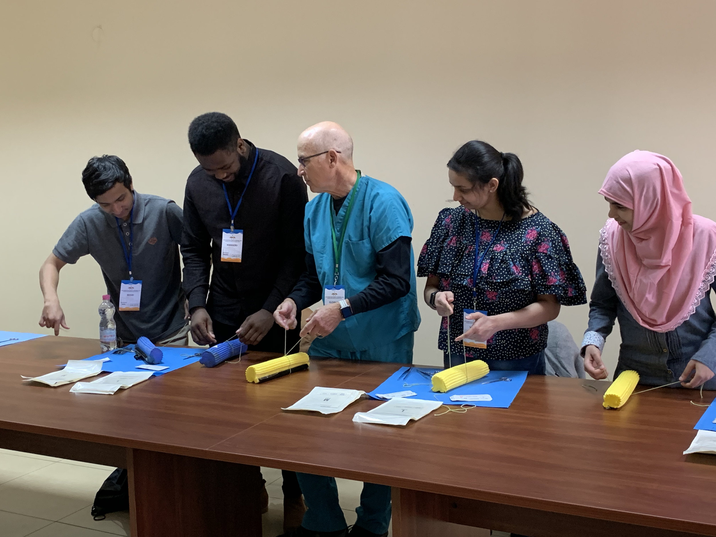 Plastic Surgeon Dr. Glenn showing off his knotting skills with the students.