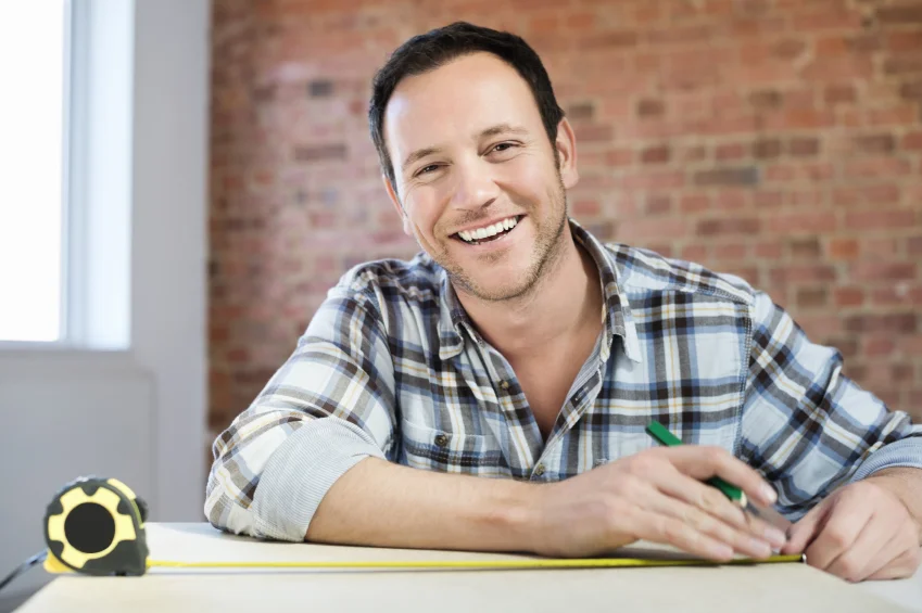 Smiling-Carpenter-Working-At-Table-000021863454_Small.jpg