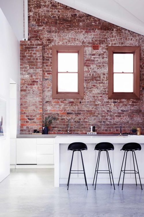Kitchen In A Loft Style With Concrete And Brick Walls And Tiles A
