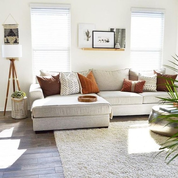 Relax in this clean, simple and streamlined family room. The design features soothing white interiors with a comfortable couch and a minimalist stylish rug. The vintage lamppost and shiny round table adds glam and sophistication. 
#RenoGuide #Minimal