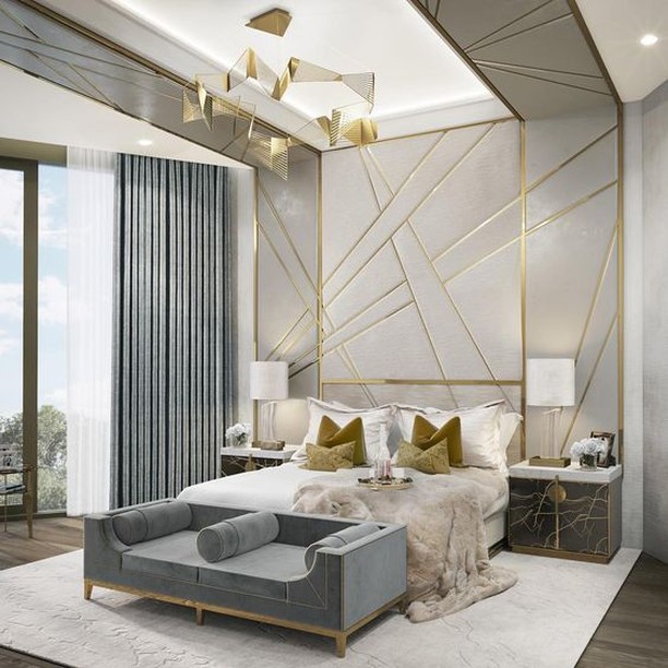 Anything plain and humdrum will never fail to look luxurious when touched by gold. This basic white and steel grey bedroom gets an opulent boost from some tasteful golden accents - pillow cases, gold insets in the wall and ceiling, gold touches on th