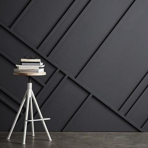 Turn a boring blank wall into a unique and fascinating home feature by adding an eye-catching woos strip patterns. This otherwise sombre black wall is made exceptional by the addition of randomly slanted wood strips. 
#RenoGuide #DIY #InteriorDesign 